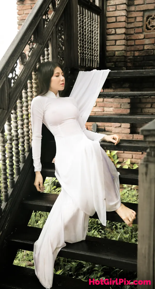 Bella Tran in wet Vietnamese traditional dress